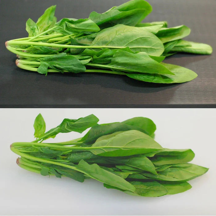 Picture of leafy green shown on black Tenryo High Contrast Cutting Board versus a white cutting board showing the  contrast and clarity difference between the two colors of cutting board.