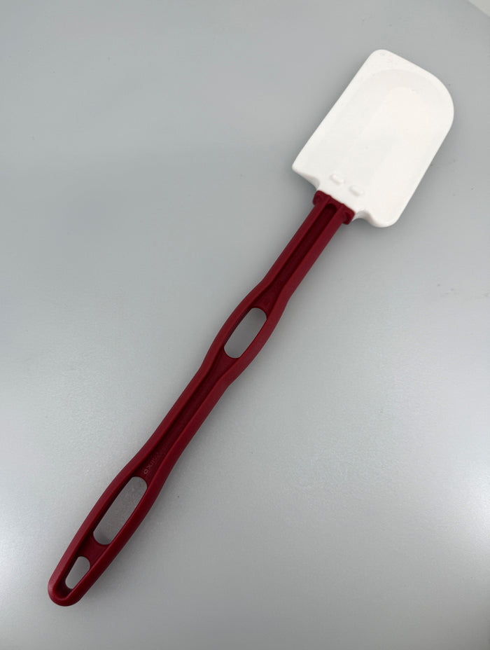 Red spatula with white head on a white background.