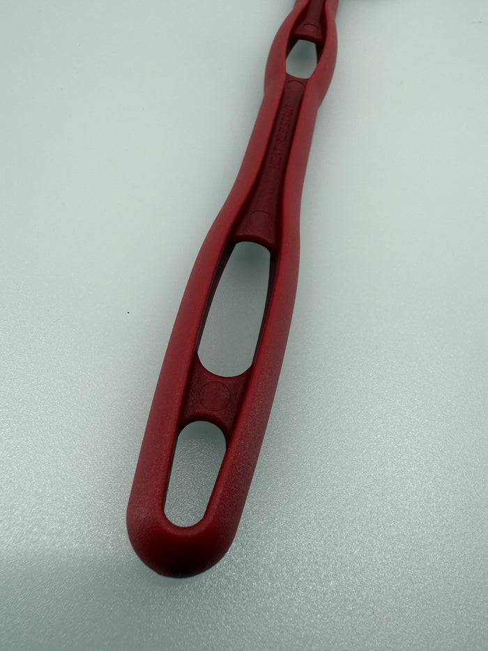 Red handle of U835 14R High Temp Spatula shot close up on white background.