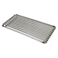 A stainless steel searing grate with parallel bars, intended for use on a grill.