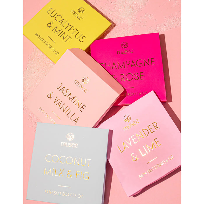 Musee bath salt soak collection displayed on pink background with multiple scented varieties