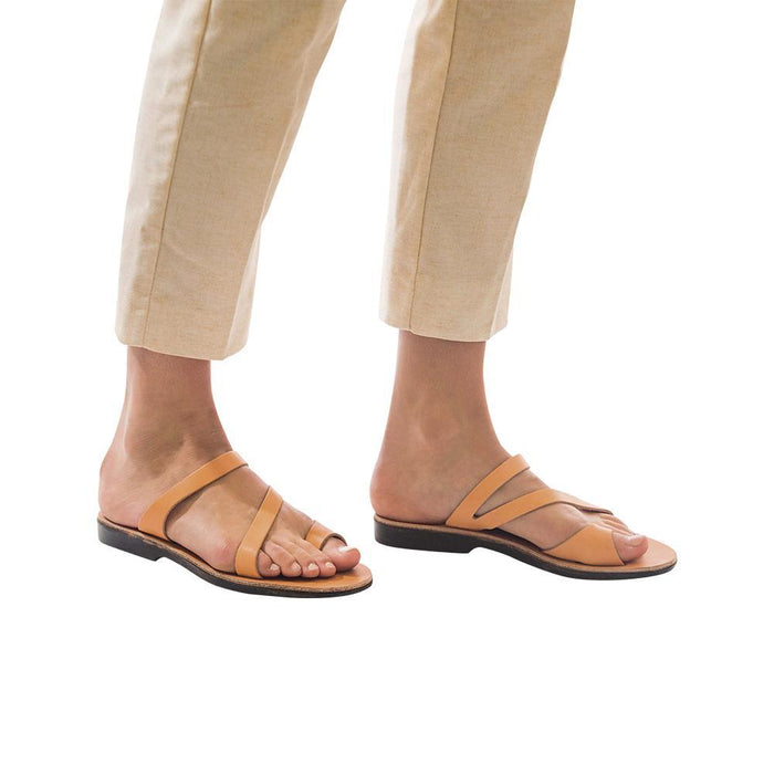 Model wearing Noah tan, handmade leather slide sandals with toe loop