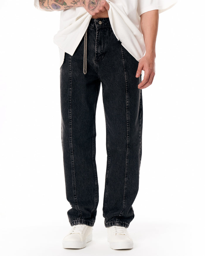 Martin Valen Urban Style washed black jeans, front waist view with decorative chain and model lifting shirt